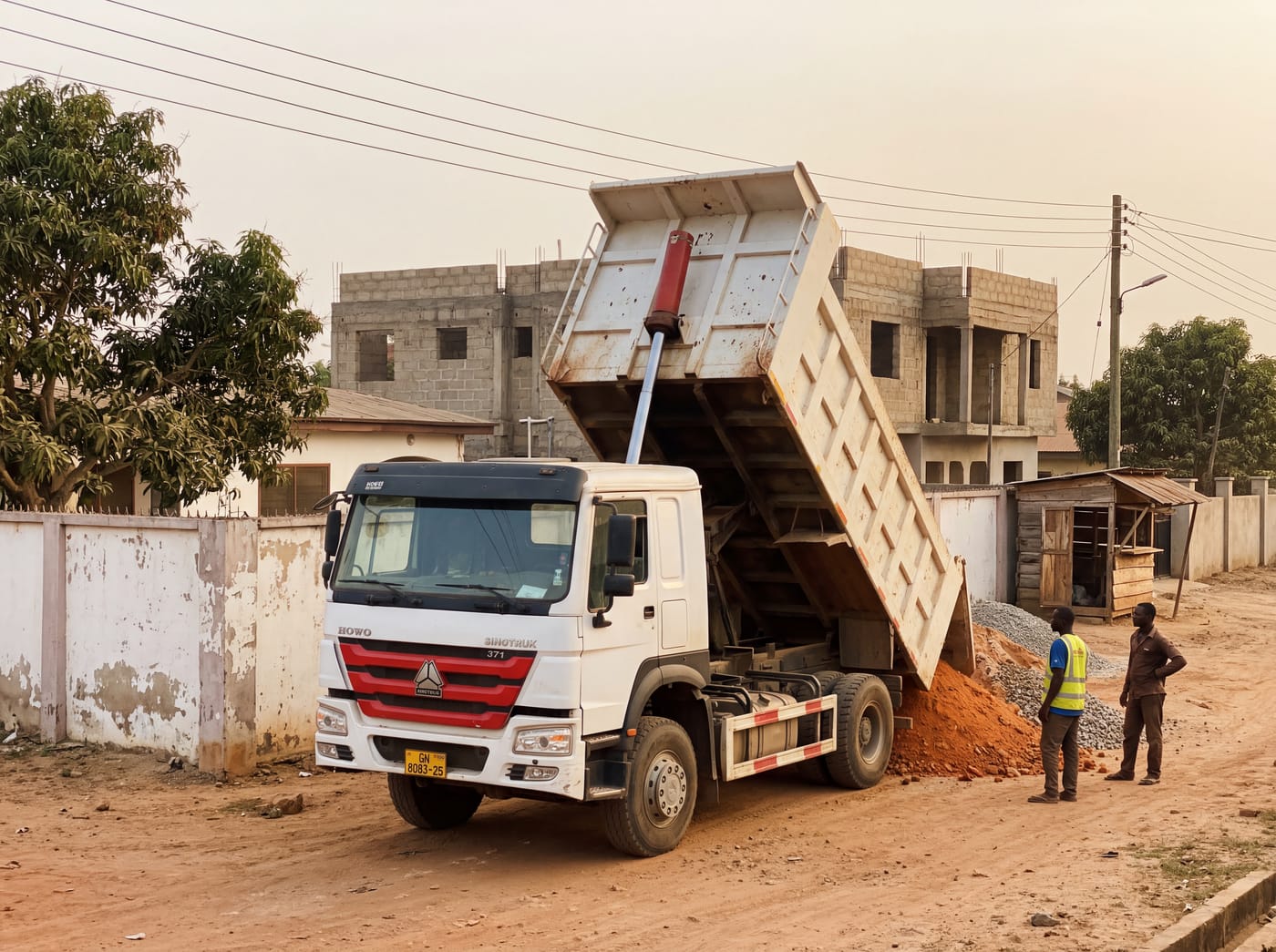A real delivery — tipper bed raised, material pouring at the site