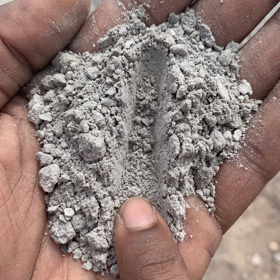 Quarry dust texture close-up, hand for scale